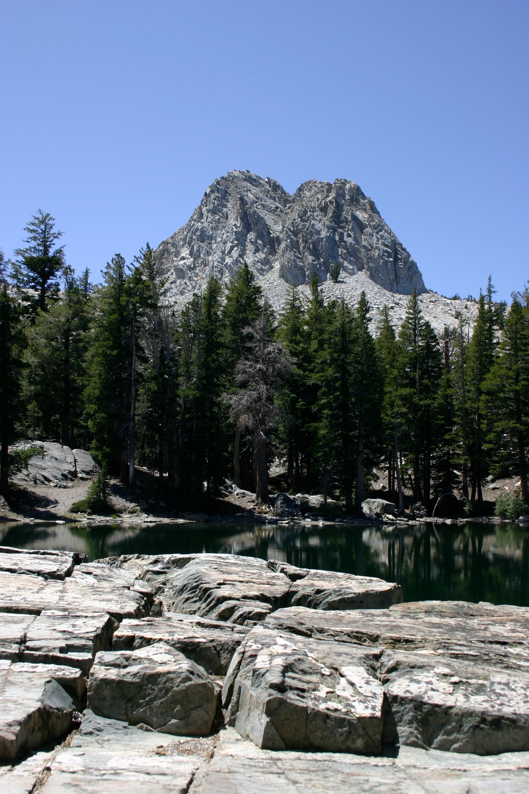 Crystal Crag and broken rocks face off at TJ Lake or Lake Barrett (not sure which).