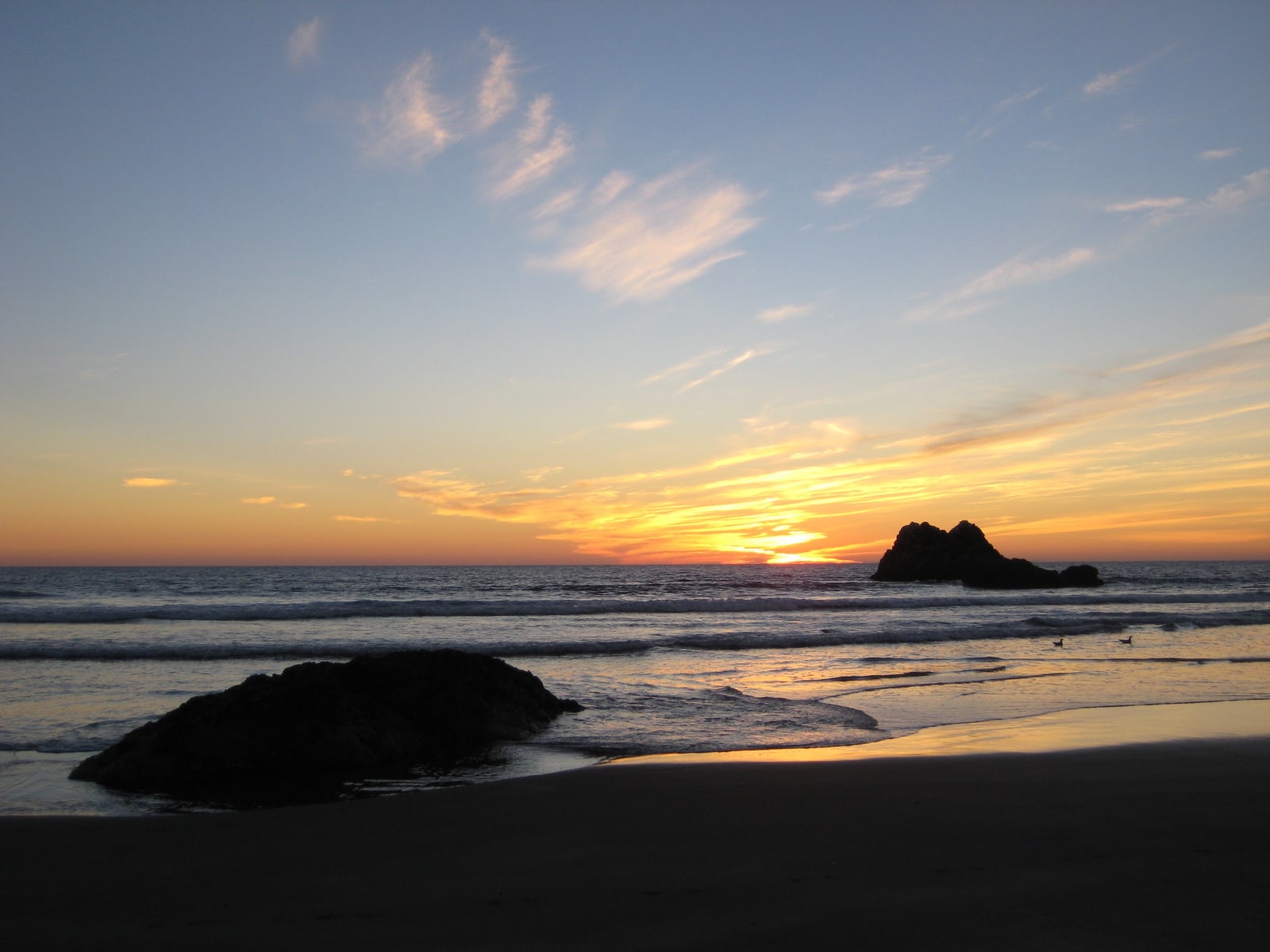 Orange sunset at the beach in Morro Bay.
